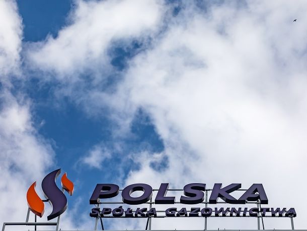Logo of Polska Spółka Gazownictwa against a background of sky with clouds