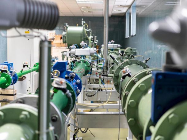 Laboratory room with green gas pipes, wiring and measuring equipment