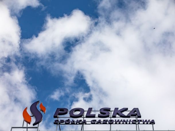 The logo of Polska Spółka Gazownictwa against a background of a cloudy sky