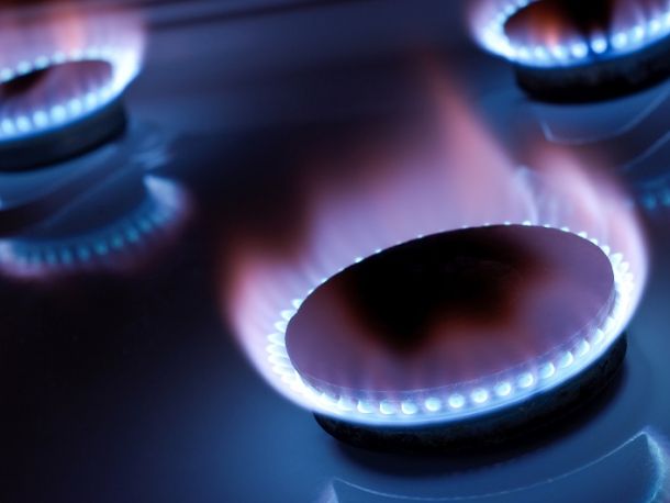 Three lit gas burners, light blue flame