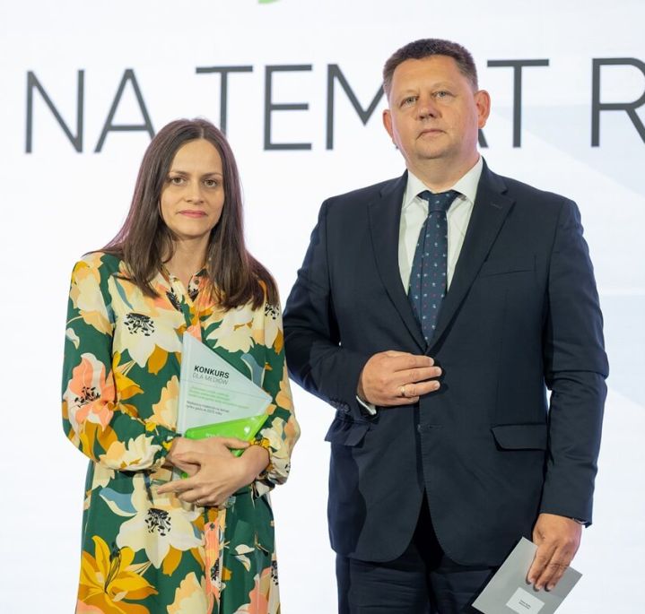 Członek zarządu PSG Jerzy Sitko stoi na scenie wraz z laureatką konkursu